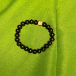 Black bracelet with one marble bead also cold soothing metal as the beads